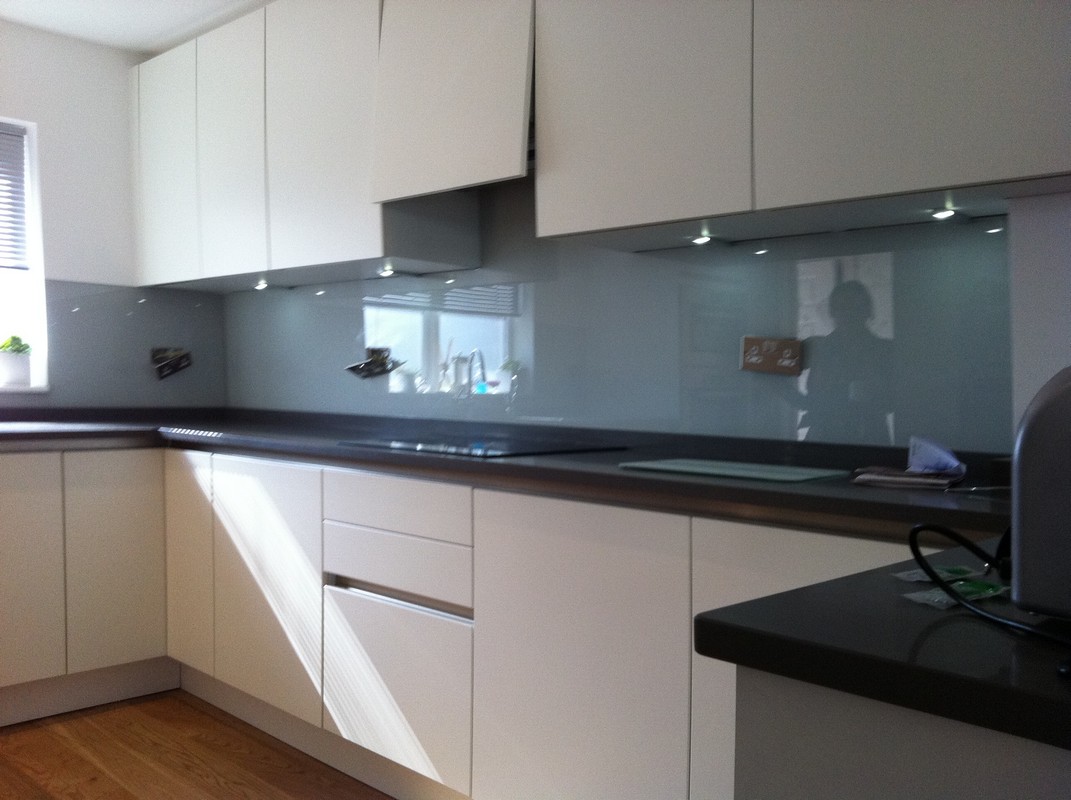 Grey glass kitchen splashback with LED lighting in St John's Wood
