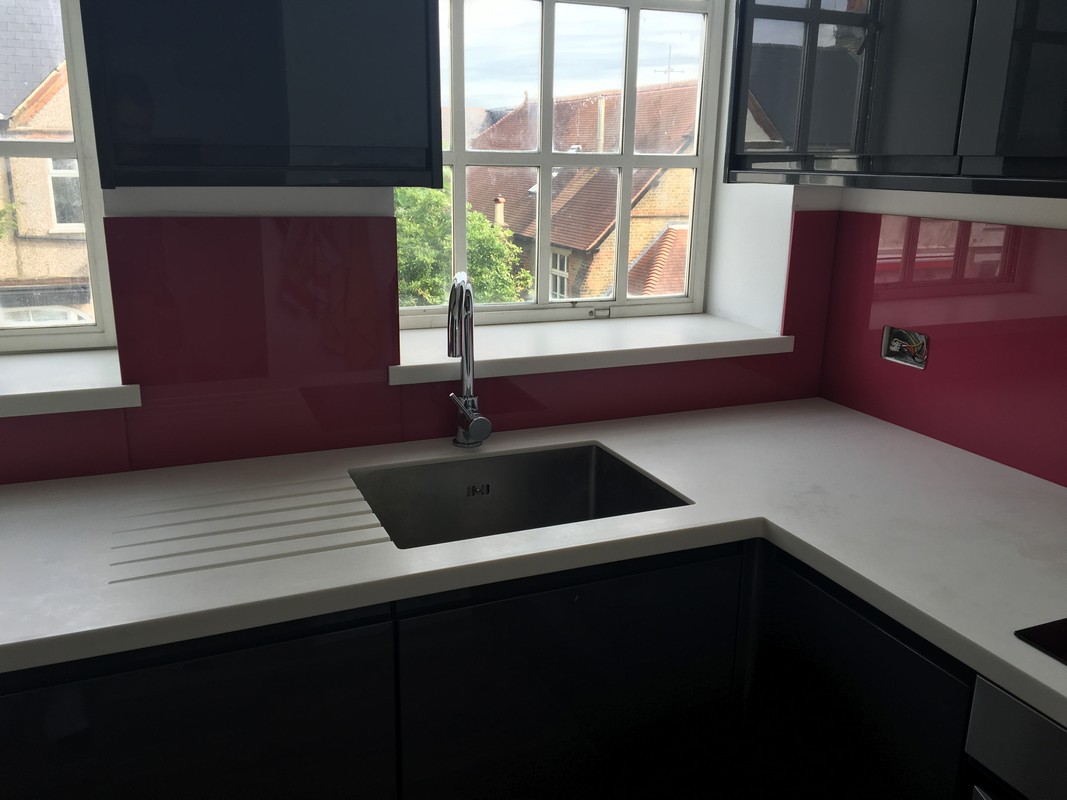 Deep plum coloured glass splashback in modern St John's Wood kitchen