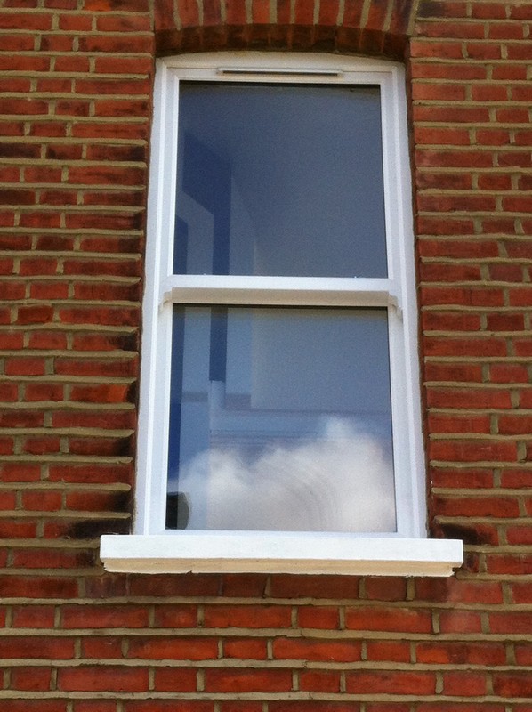 uPVC sash window on Victorian red brick house in St John's Wood